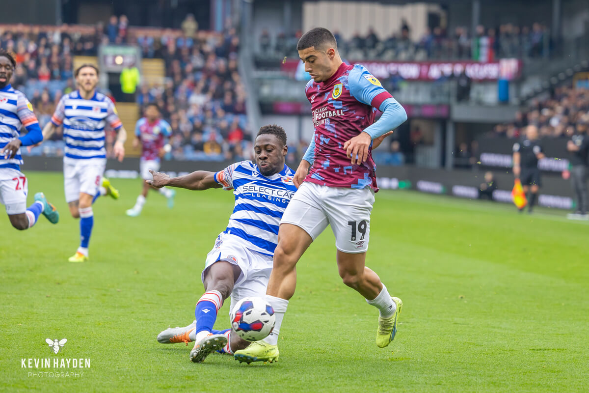 A Reading player makes a tackle against Burnley's Anaas Zaroury in an EFL Championship game at Turf Moor, Burnley. Photo by Kevin Hayden.